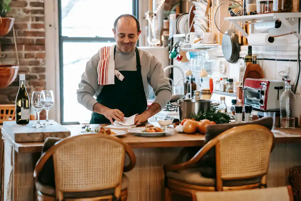 Chef preparing a dish with fresh pasta in a wine bar
