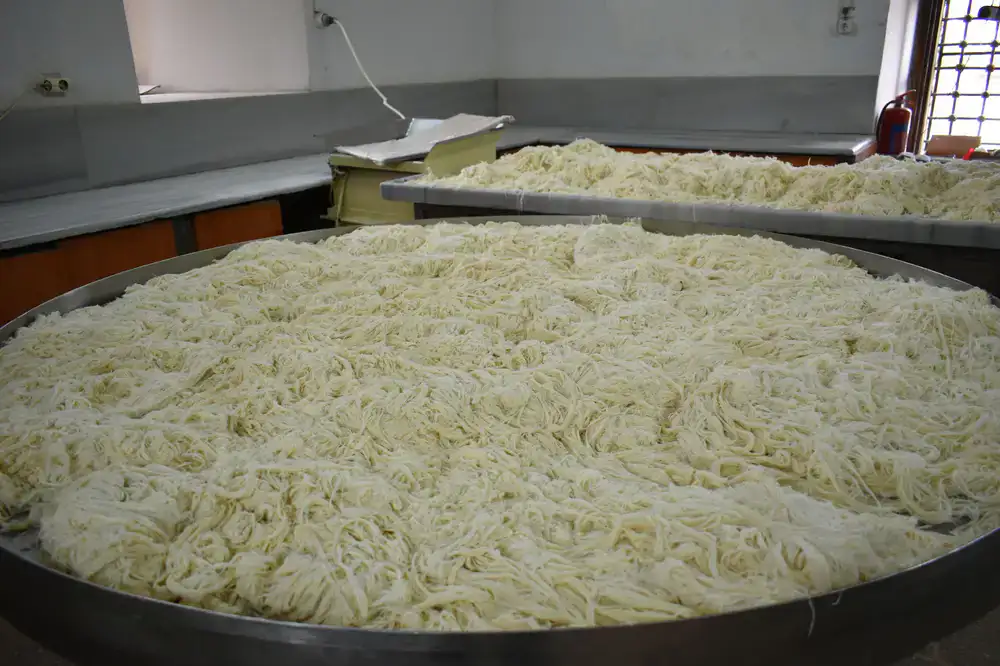Large trays of fresh pasta ready for professional kitchen distribution