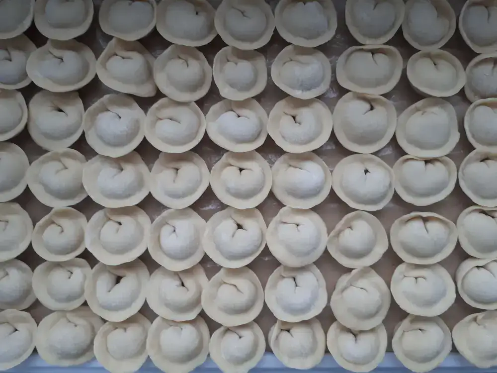 Close up of a chef folding delicate tortellini